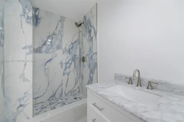 a bathroom with a sink and a shower