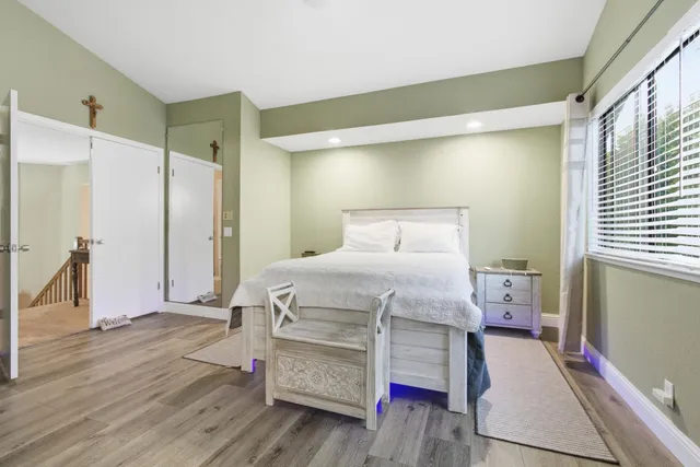 a bedroom with a bed and a mirror