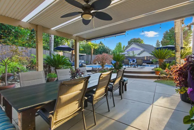 a view of a patio with a table and chairs