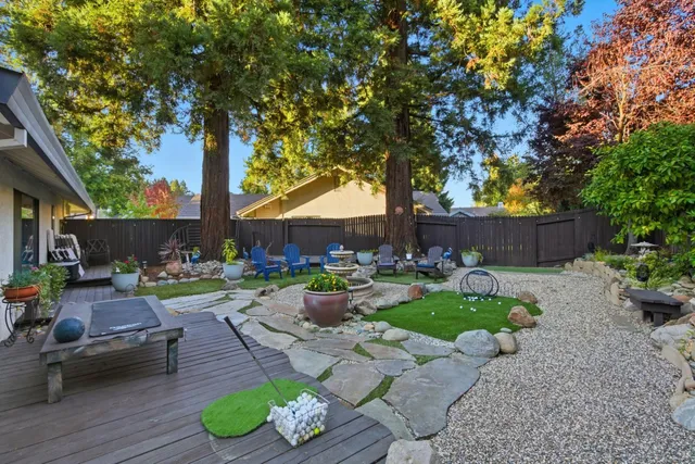 a view of a backyard with sitting area furniture and a fire pit