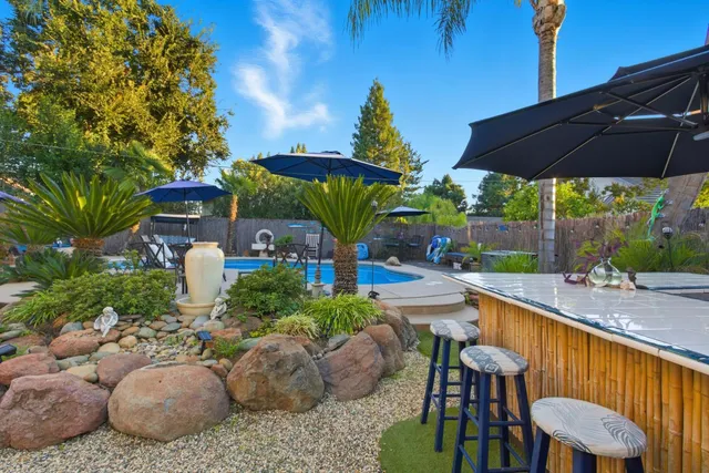 a view of a table and chairs under an umbrella in patio
