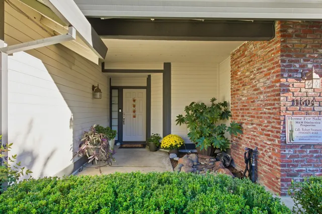 a backyard of a house with outdoor seating