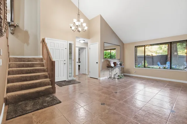 a living room with furniture and a floor to ceiling window