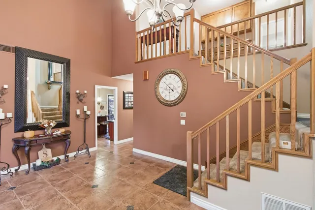 a view of a hallway with wooden floor and a large mirror