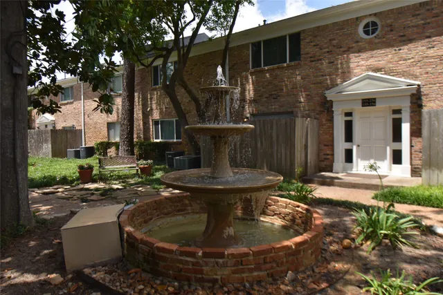 a view of a house with sitting area and garden
