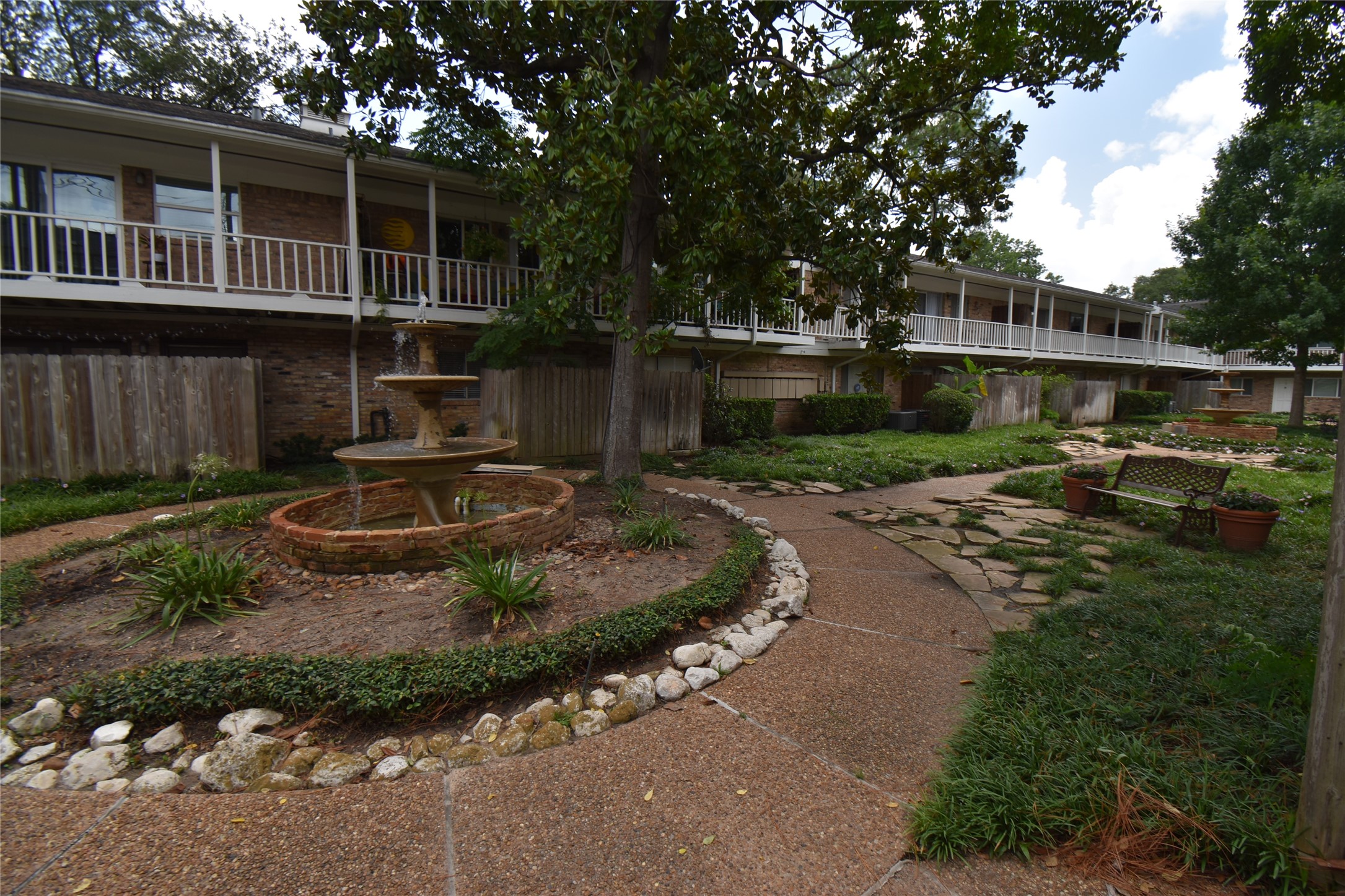 4040 San Felipe Street, Unit 155 Houston, TX 77027 - Photo 3 of 15 a backyard of a house with yard fire pit barbeque oven and outdoor seating