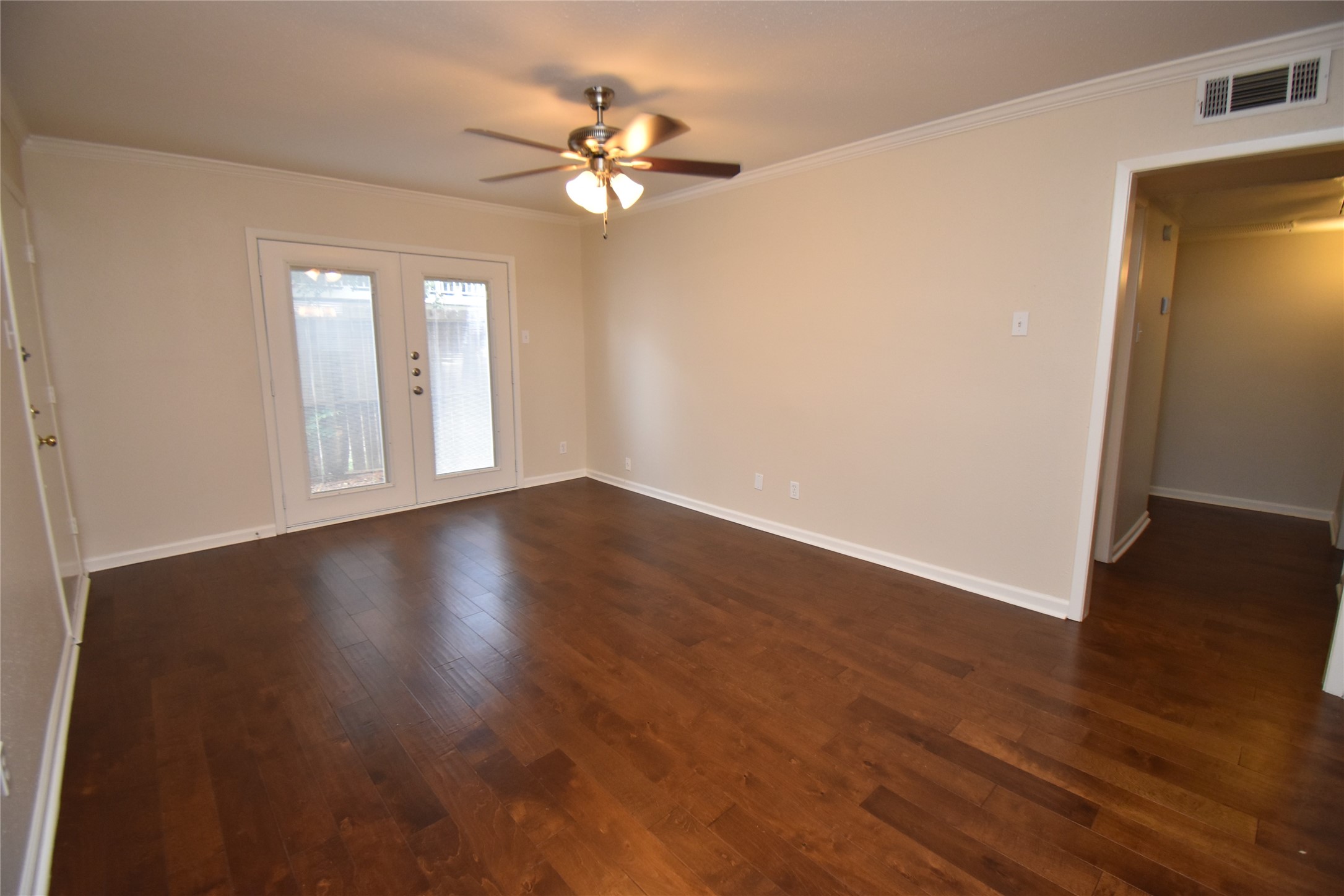 4040 San Felipe Street, Unit 155 Houston, TX 77027 - Photo 4 of 15 a view of an empty room with wooden floor and a window