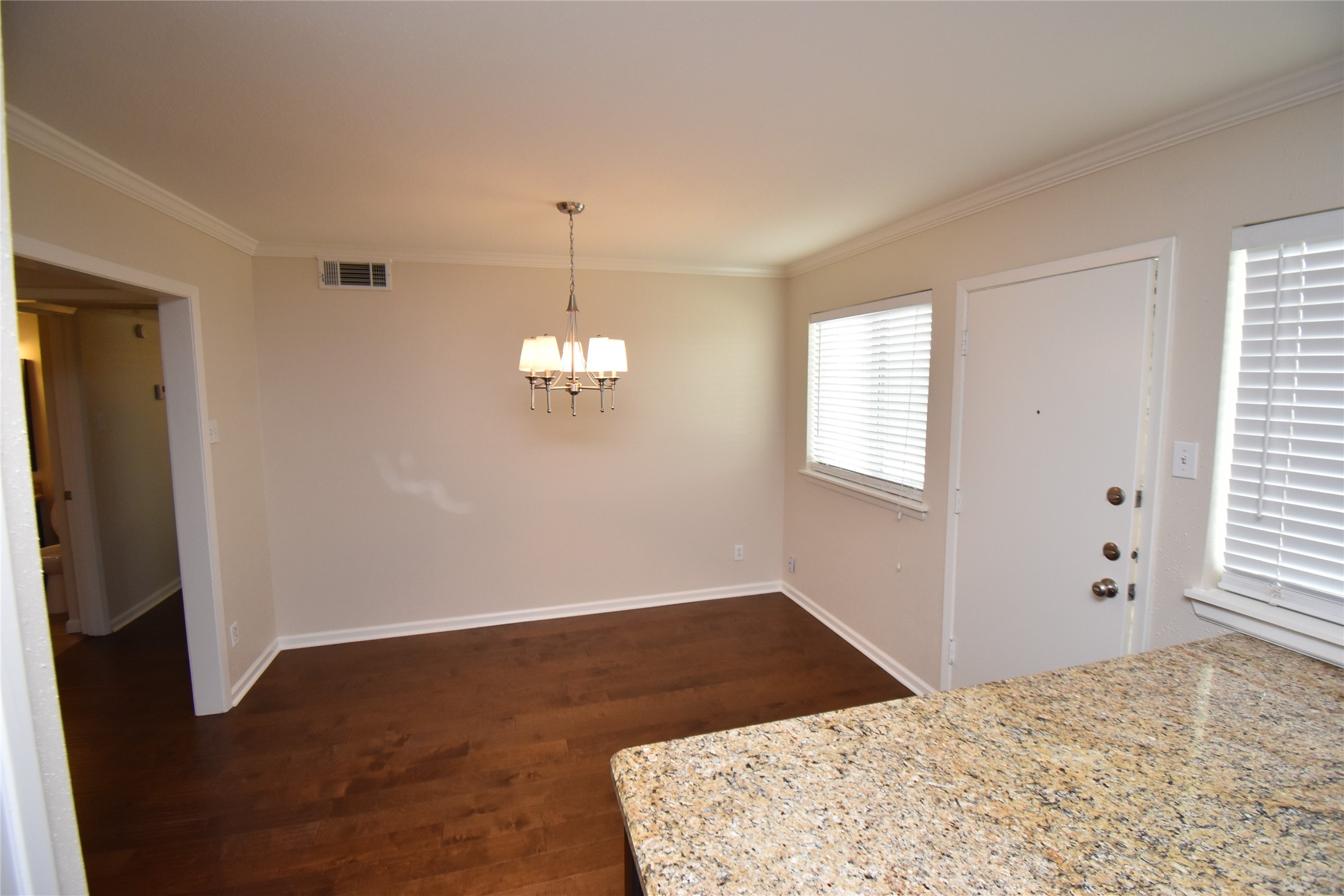 4040 San Felipe Street, Unit 155 Houston, TX 77027 - Photo 6 of 15 a view of empty room with wooden floor and window