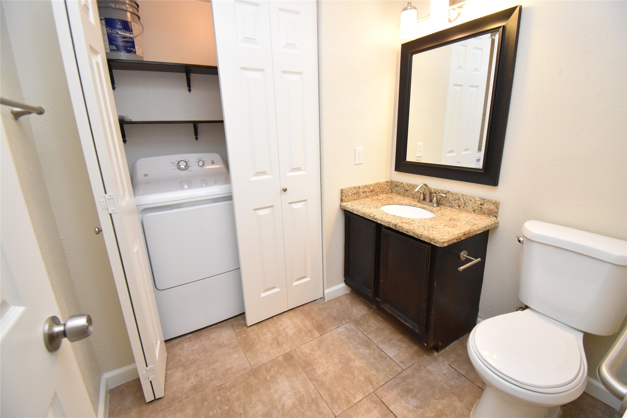 4040 San Felipe Street, Unit 155 Houston, TX 77027 - Photo 9 of 15 a bathroom with a toilet sink and mirror