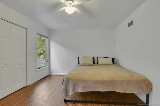 a bedroom with a bed and a chair