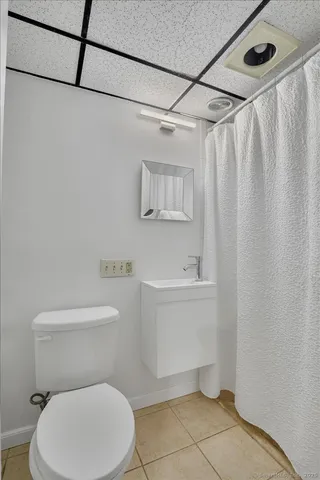 a view of wooden deck with furniture and trees around