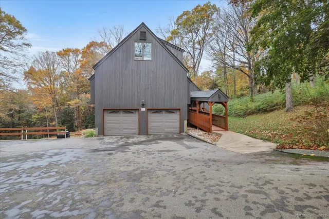 a view of a house with backyard and a tree