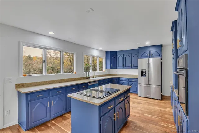 a kitchen with stainless steel appliances granite countertop a refrigerator sink and cabinets