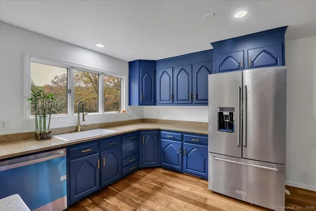 a kitchen with sink and wooden cabinets