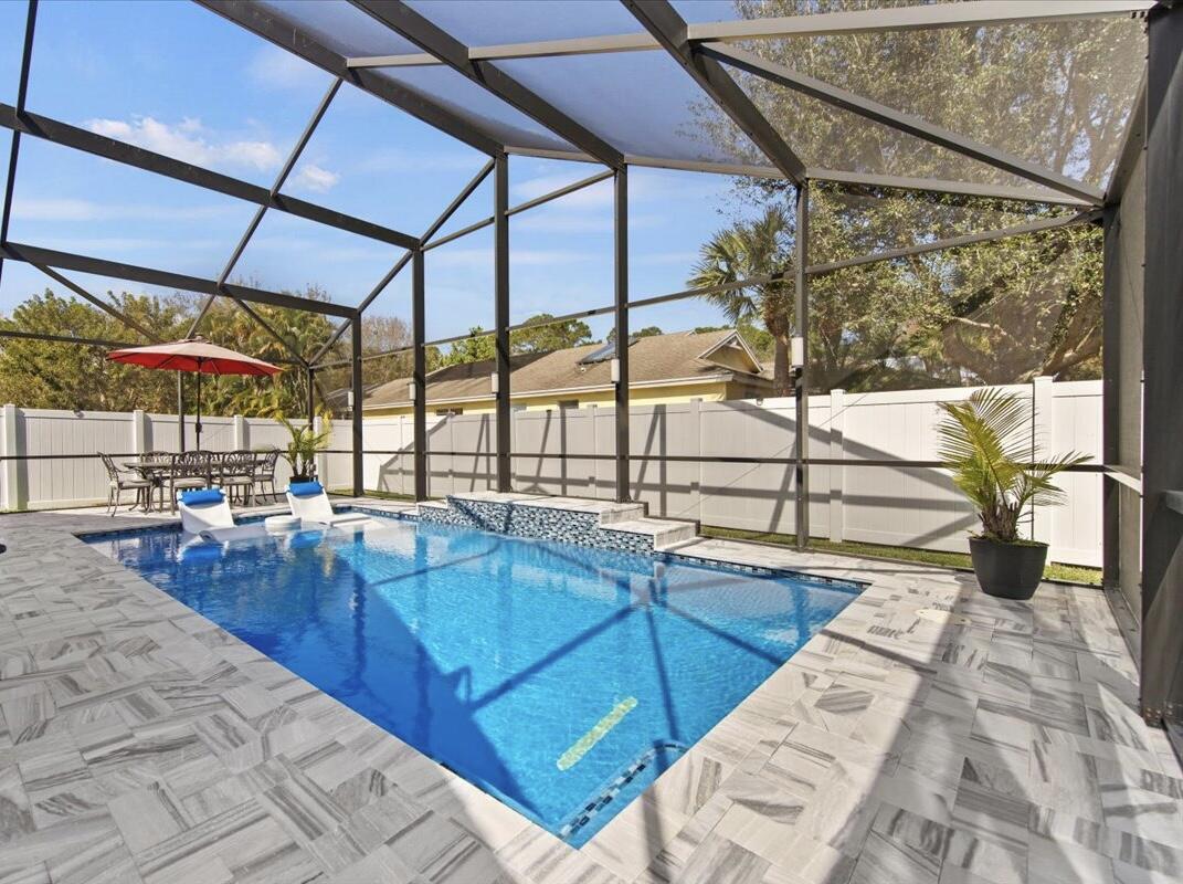 2789 Southwest Riviera Road Stuart, FL 34997 - Photo 29 of 65 Travertine Tiled pool area