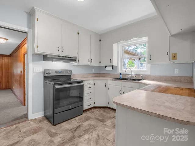 a kitchen with a sink stove and cabinets