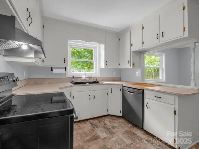 a kitchen with a sink stove and cabinets