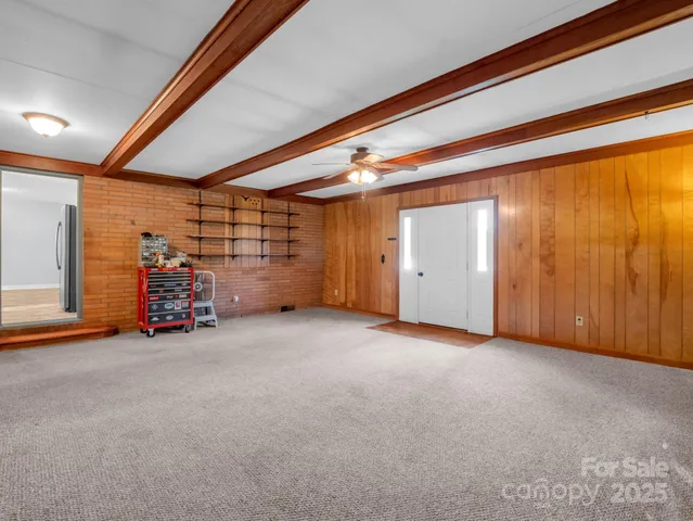 a view of a big room with air conditioner duct and materials on floor