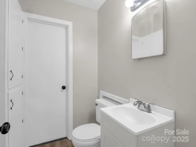 a white toilet sitting next to a bathroom sink