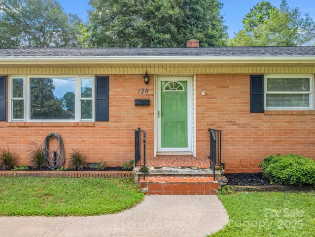 a front view of a house with a garden and yard