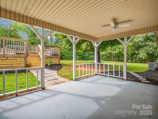 a view of a backyard with floor to ceiling window and an outdoor space