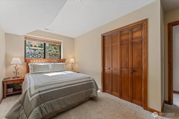 a view of a lake with couches chairs