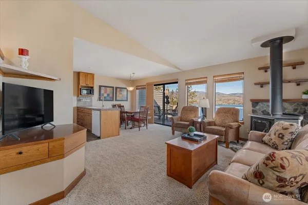 a kitchen with granite countertop a sink stove and refrigerator