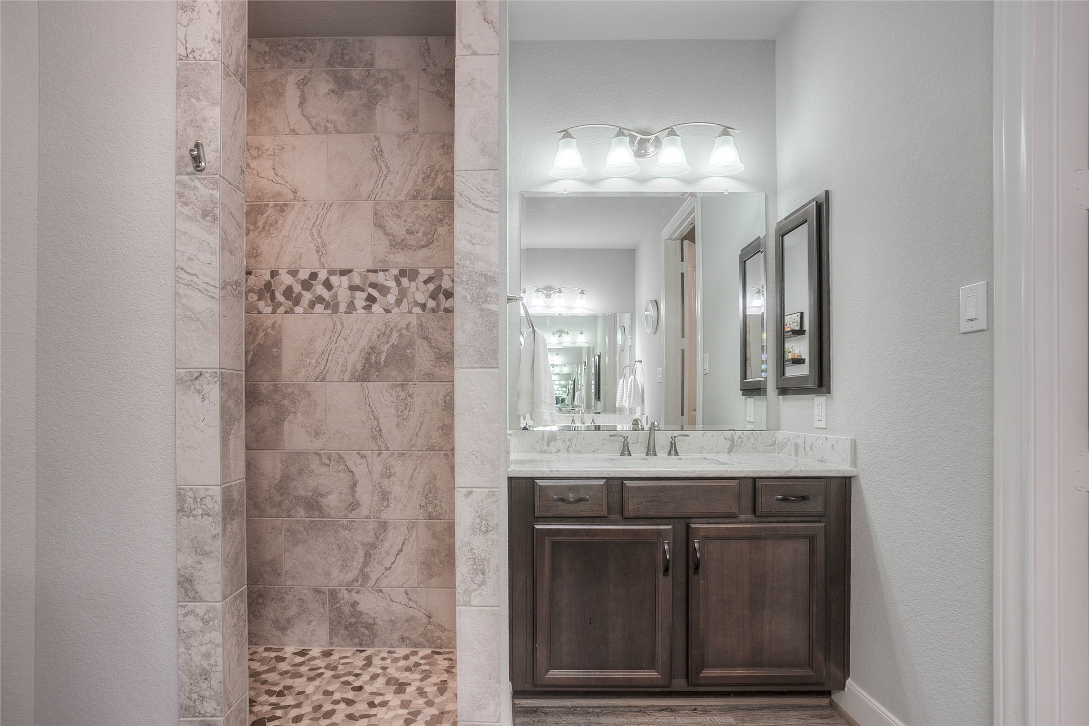 5757 Lakeside Villas Court Conroe, TX 77304 - Photo 28 of 50 a bathroom with a granite countertop shower a sink and a mirror
