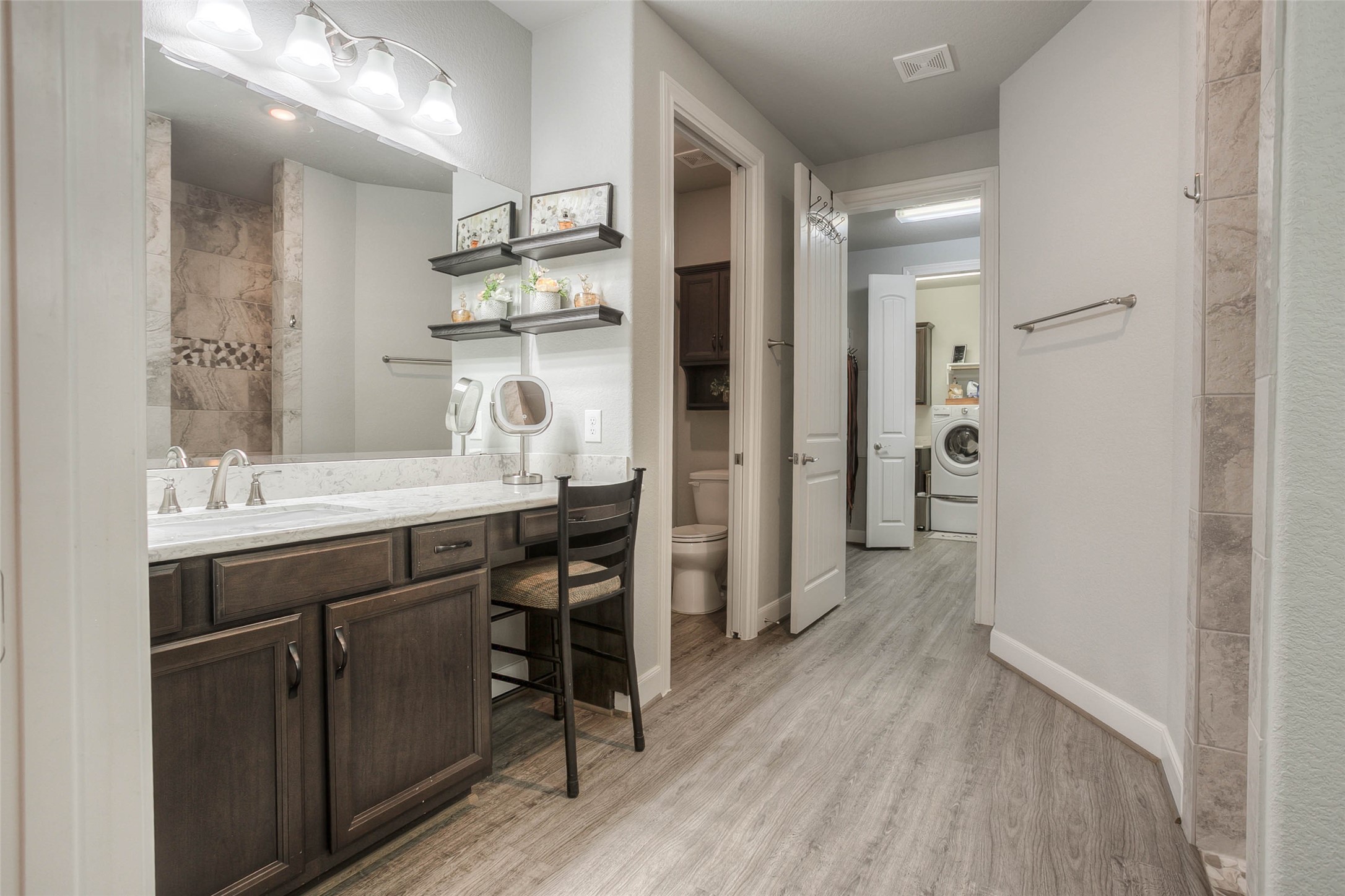 5757 Lakeside Villas Court Conroe, TX 77304 - Photo 31 of 50 a bathroom with a sink shower and a mirror