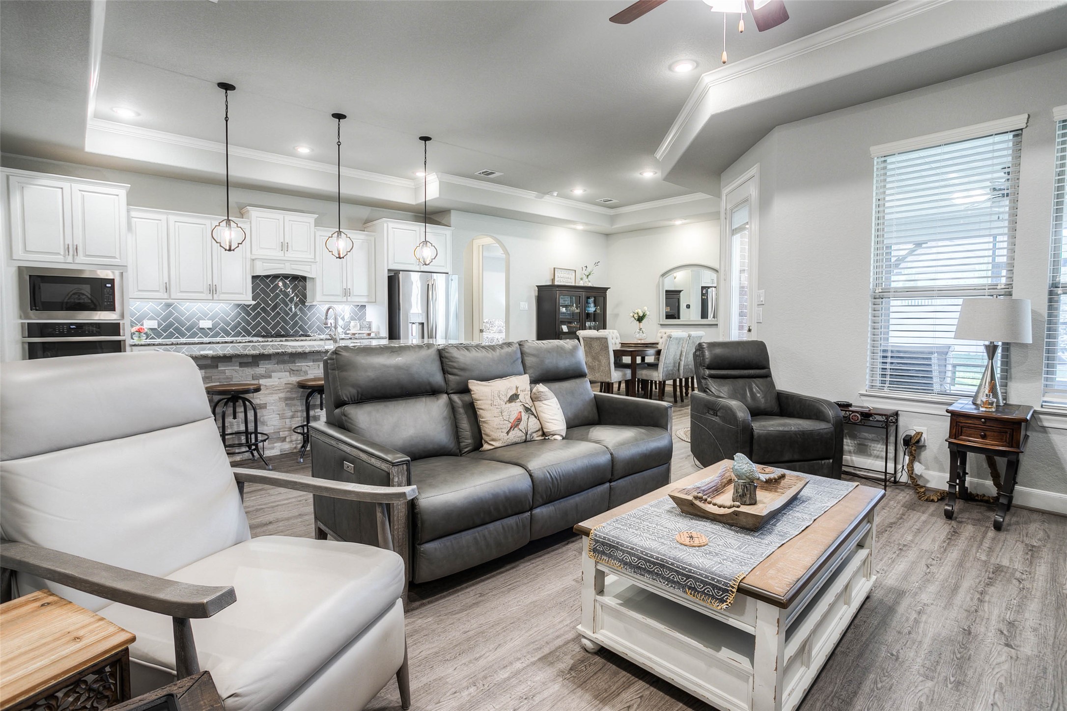 5757 Lakeside Villas Court Conroe, TX 77304 - Photo 4 of 50 a living room with furniture kitchen view and a wooden floor