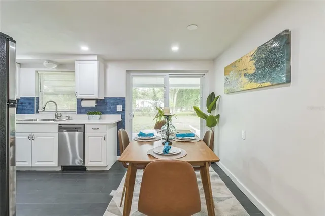 a very nice looking dining room with a large window