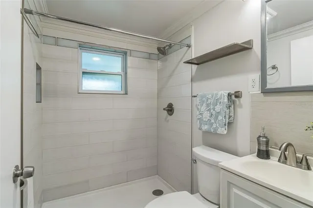 a bathroom with a shower a toilet and sink