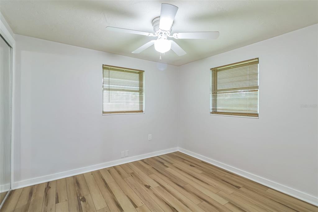 5390 South Manatee Terrace Homosassa, FL 34446 - Photo 18 of 25 a view of an empty room with wooden floor and a window