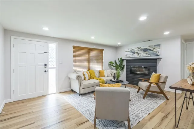 a living room with furniture and a fireplace