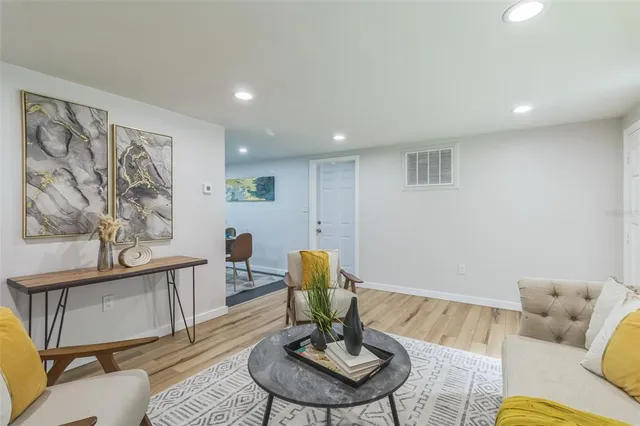 a living room with furniture and a dining table