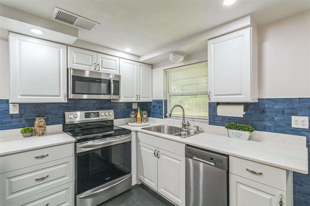 5390 South Manatee Terrace Homosassa, FL 34446 - Photo 8 of 25 a kitchen with a sink stove top oven and microwave
