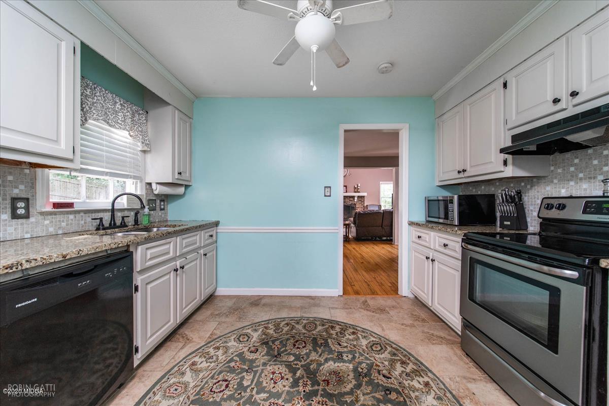 6431 Stapleton Road Macon, GA 31206 - Photo 11 of 29 a kitchen with stainless steel appliances granite countertop a stove sink and cabinets