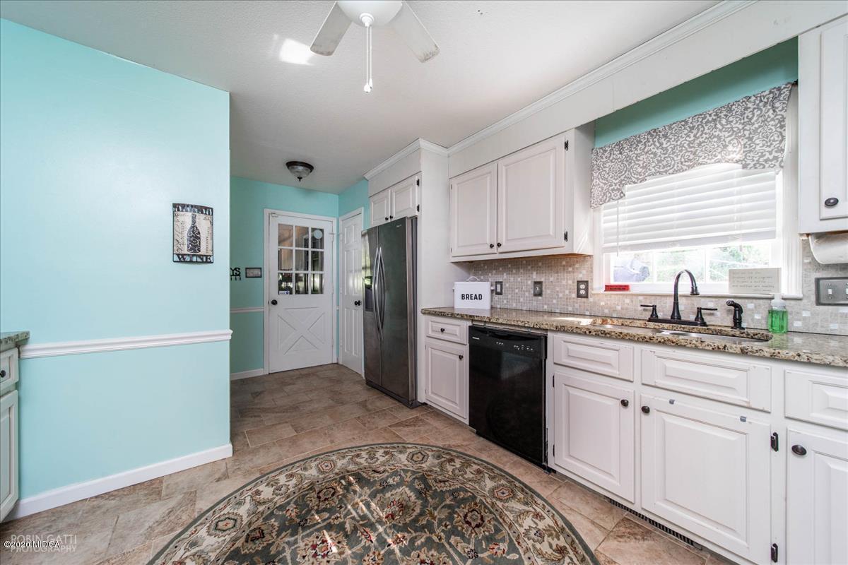 6431 Stapleton Road Macon, GA 31206 - Photo 12 of 29 a kitchen with granite countertop a refrigerator sink and cabinets