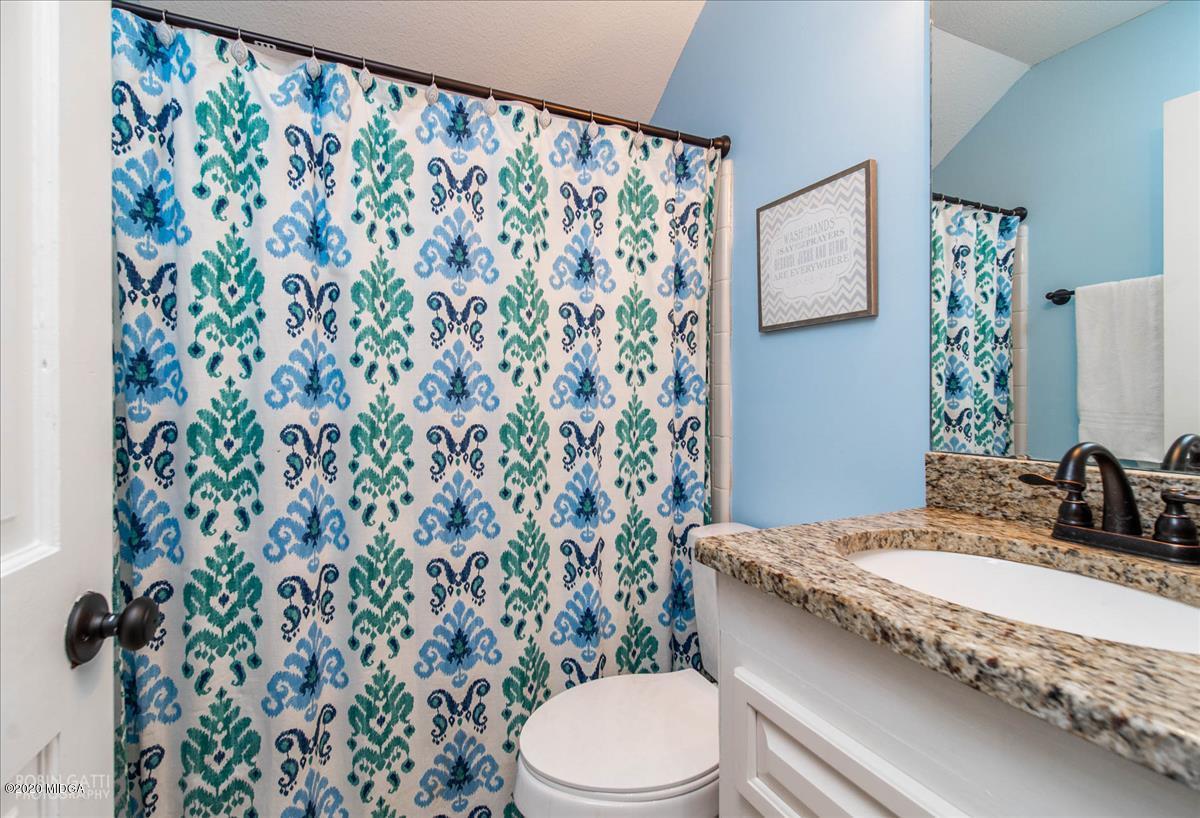 6431 Stapleton Road Macon, GA 31206 - Photo 18 of 29 a bathroom with a granite countertop sink and a toilet