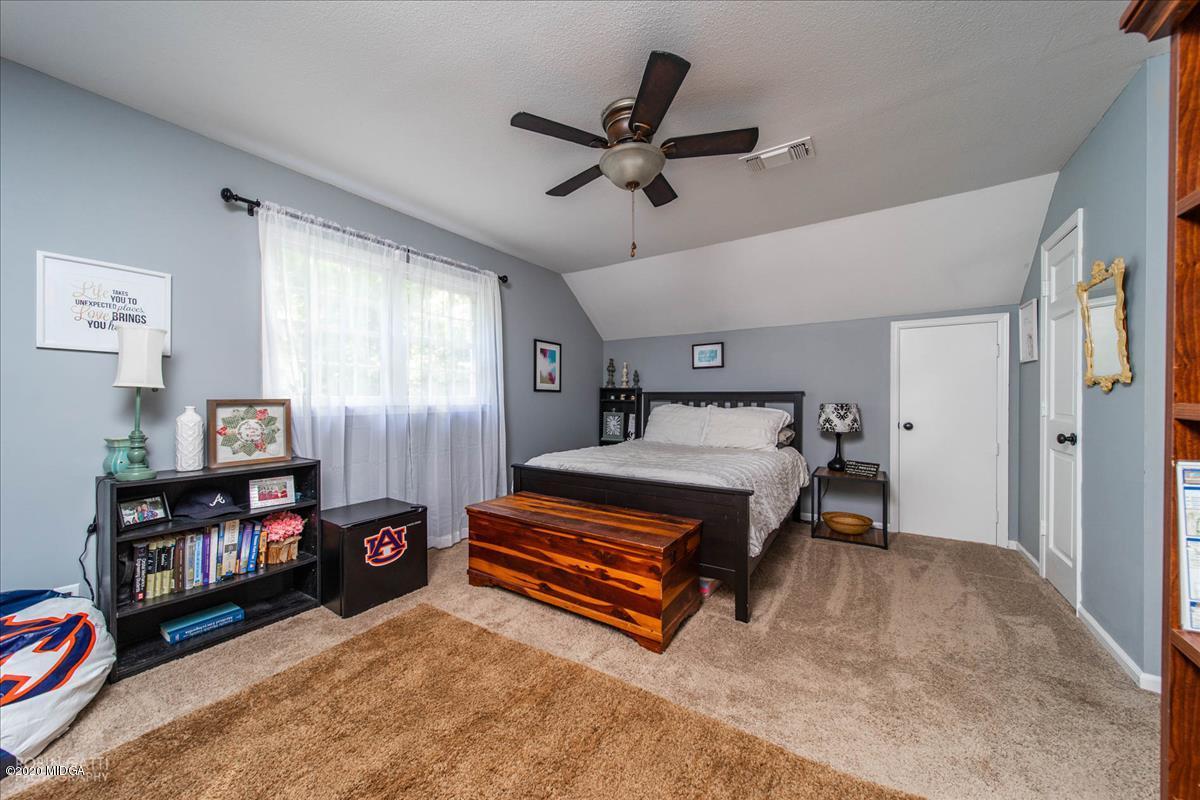 6431 Stapleton Road Macon, GA 31206 - Photo 20 of 29 a bedroom with furniture and a window
