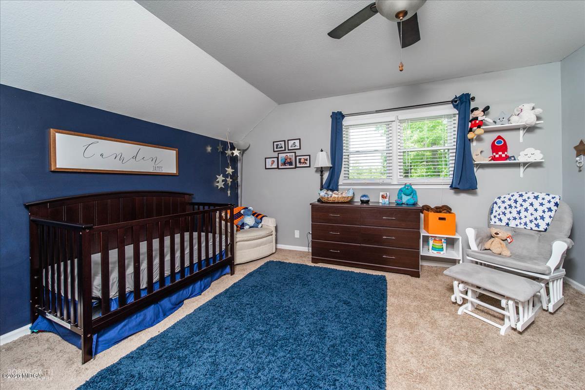 6431 Stapleton Road Macon, GA 31206 - Photo 21 of 29 a bedroom with furniture and a window