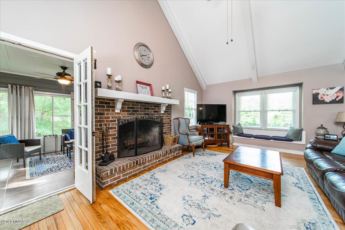 6431 Stapleton Road Macon, GA 31206 - Photo 4 of 29 a living room with furniture a flat screen tv and a fireplace
