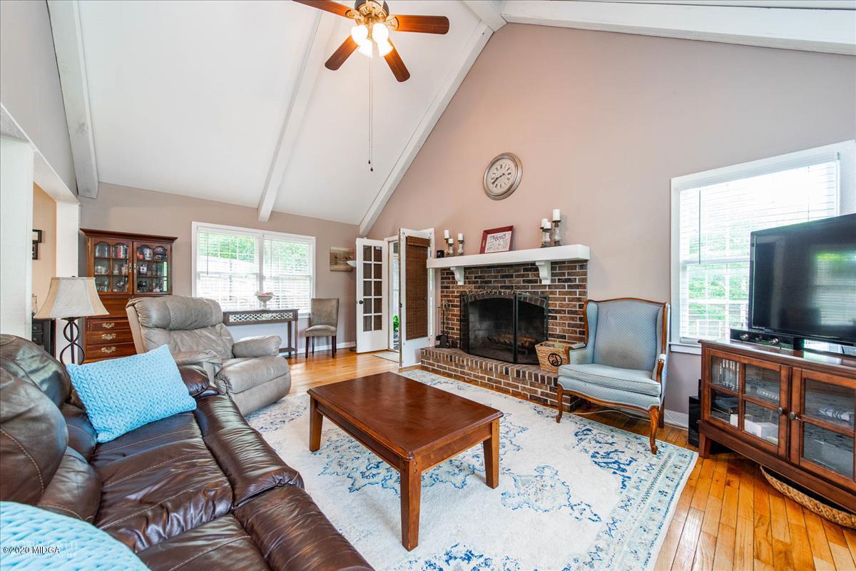 6431 Stapleton Road Macon, GA 31206 - Photo 5 of 29 a living room with furniture a flat screen tv and a fireplace