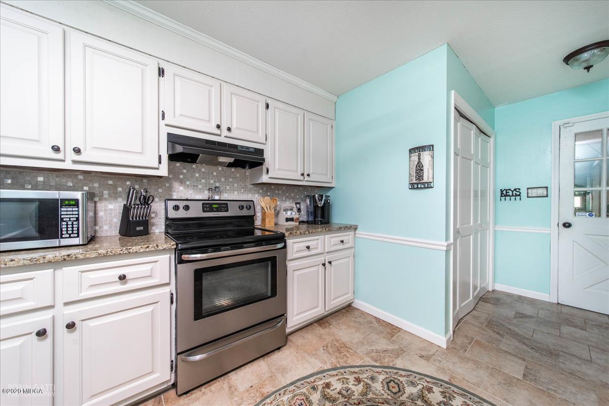 6431 Stapleton Road Macon, GA 31206 - Photo 10 of 29 a kitchen with stainless steel appliances granite countertop a stove a sink and a refrigerator