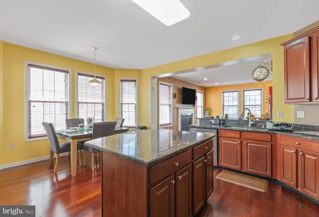 a open kitchen with granite countertop a sink and cabinets