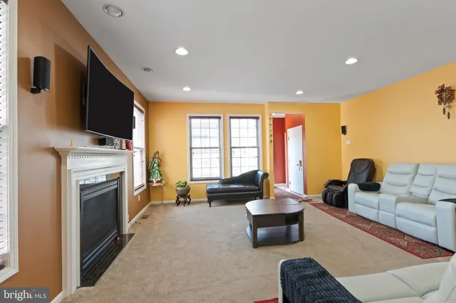 a living room with furniture flat screen tv and a fireplace