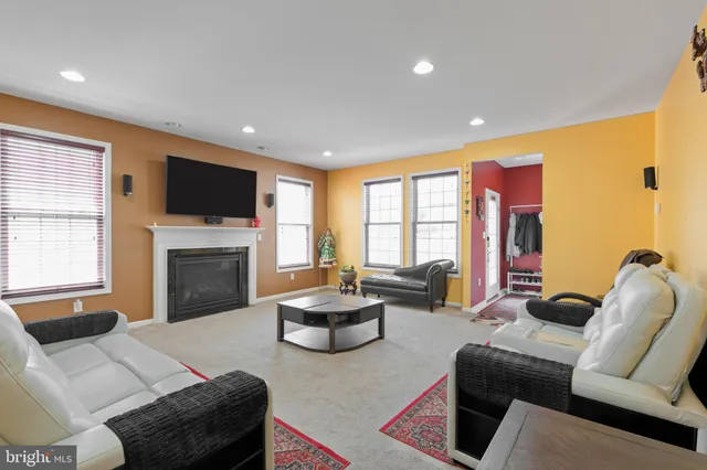 a living room with furniture fireplace and a flat screen tv