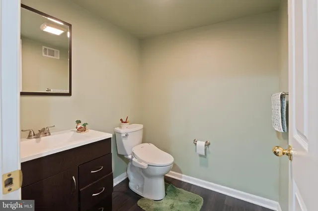 a view of living room with furniture and wooden floor