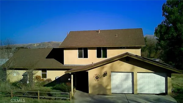 a house with trees in the background