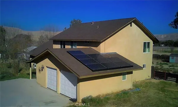 a aerial view of a house with a yard